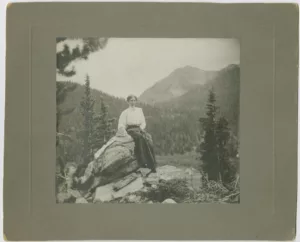 A woman sits on a rock outcropping in a Breckenridge History Archives photo